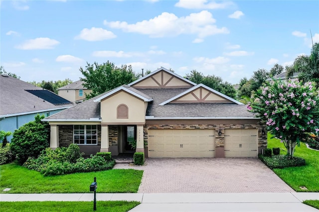 view of front of house with a garage and a front yard