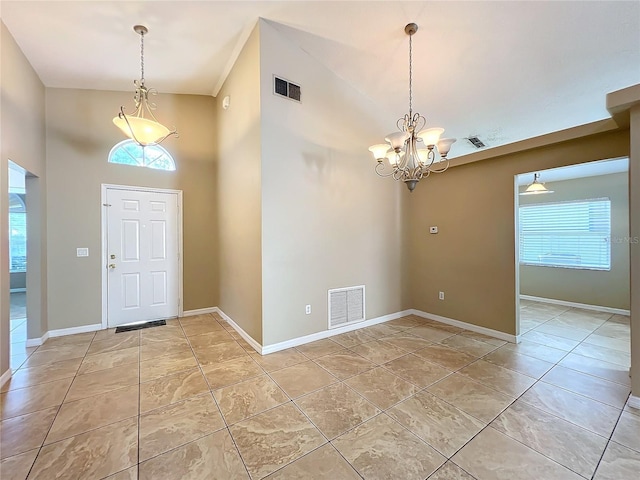 entrance foyer with light tile patterned floors, a high ceiling, and a notable chandelier