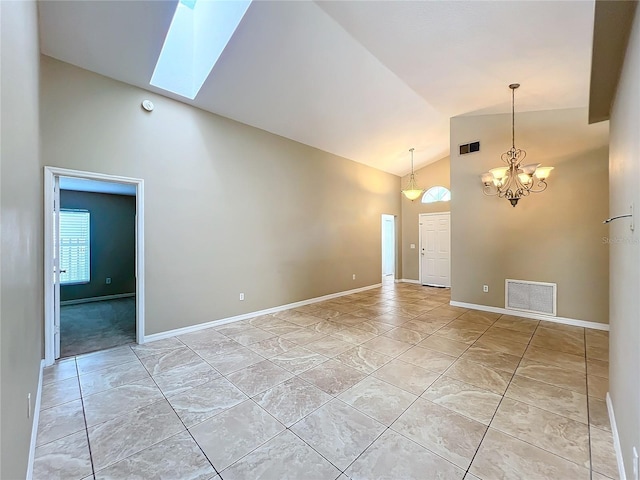 spare room with high vaulted ceiling, a notable chandelier, and light tile patterned floors