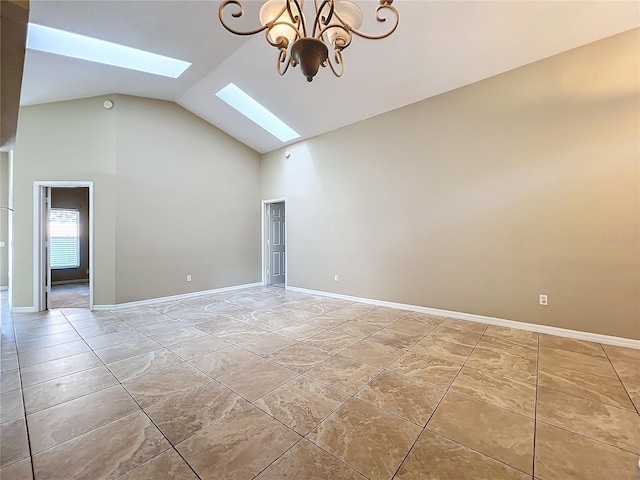 empty room featuring high vaulted ceiling and a skylight