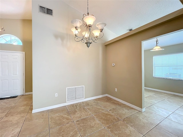 unfurnished dining area featuring a textured ceiling, high vaulted ceiling, a chandelier, and light tile patterned floors