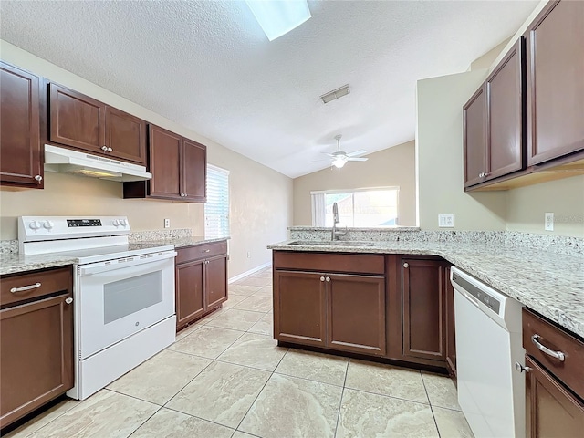 kitchen featuring white appliances, a textured ceiling, ceiling fan, sink, and kitchen peninsula