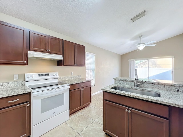 kitchen featuring vaulted ceiling, sink, light tile patterned floors, a textured ceiling, and electric range