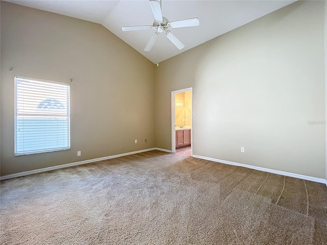 spare room featuring ceiling fan, high vaulted ceiling, and carpet