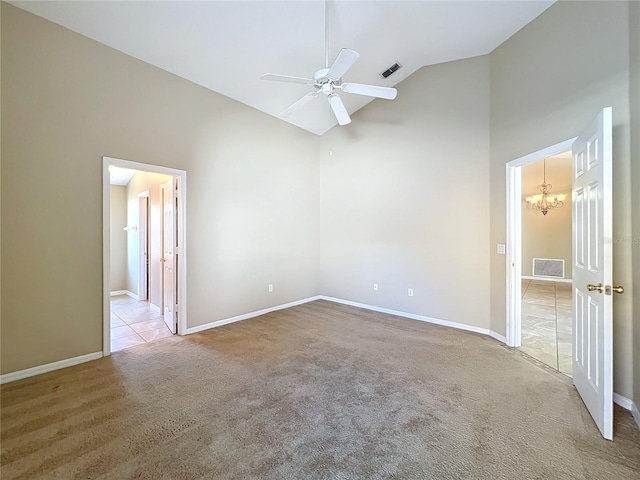 spare room with high vaulted ceiling, light colored carpet, and ceiling fan