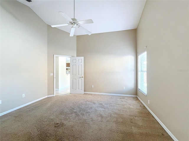 unfurnished room featuring ceiling fan, high vaulted ceiling, and carpet floors