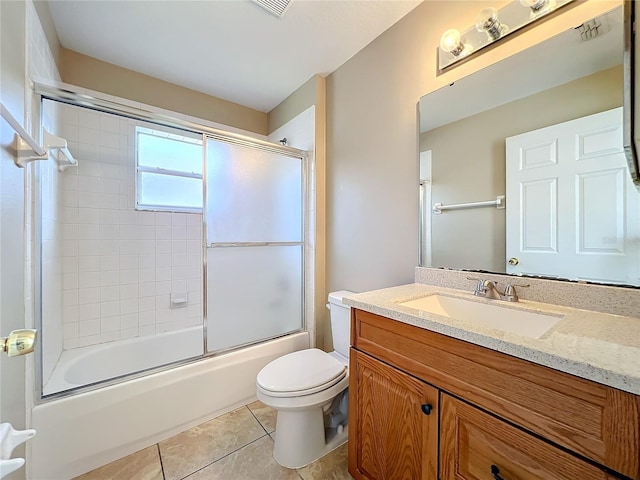 full bathroom featuring vanity, tile patterned flooring, toilet, and enclosed tub / shower combo