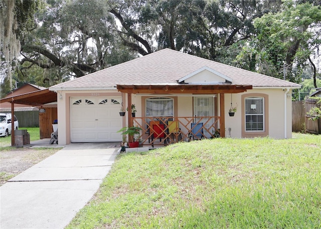 ranch-style house with a front yard, a porch, and a carport