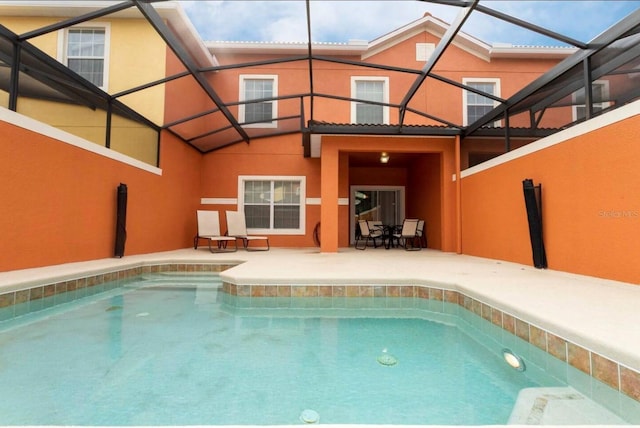 view of pool featuring a patio and glass enclosure