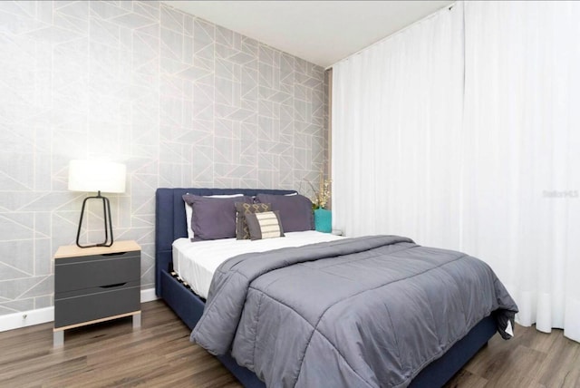 bedroom featuring tile walls and dark hardwood / wood-style floors