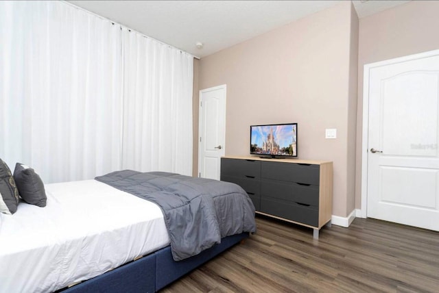 bedroom featuring dark wood-type flooring