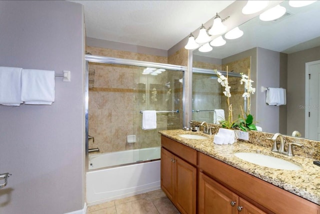 bathroom featuring vanity, combined bath / shower with glass door, and tile patterned floors