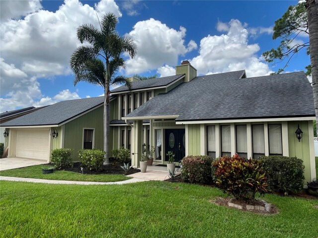 view of front of house featuring a front yard and a garage