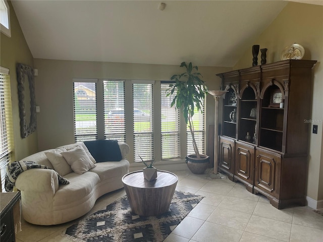 tiled living room featuring lofted ceiling