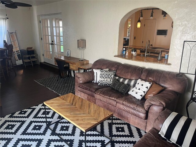 living room featuring french doors, dark hardwood / wood-style flooring, and ceiling fan