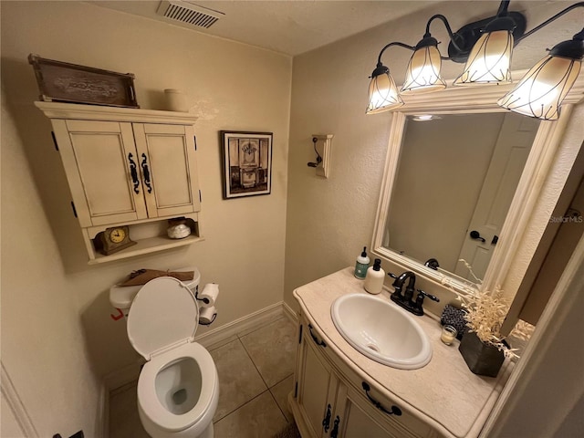 bathroom with tile patterned flooring, vanity, and toilet