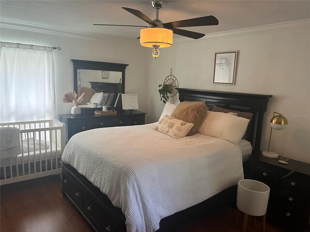 bedroom featuring dark hardwood / wood-style floors, ceiling fan, and crown molding