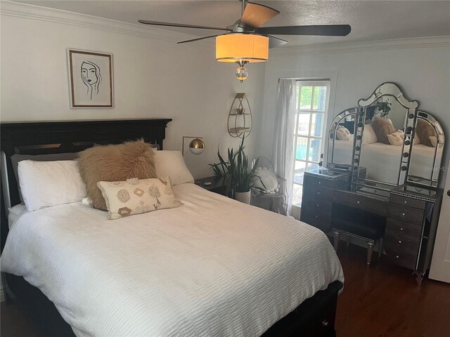 bedroom with a textured ceiling, dark hardwood / wood-style floors, ceiling fan, and crown molding