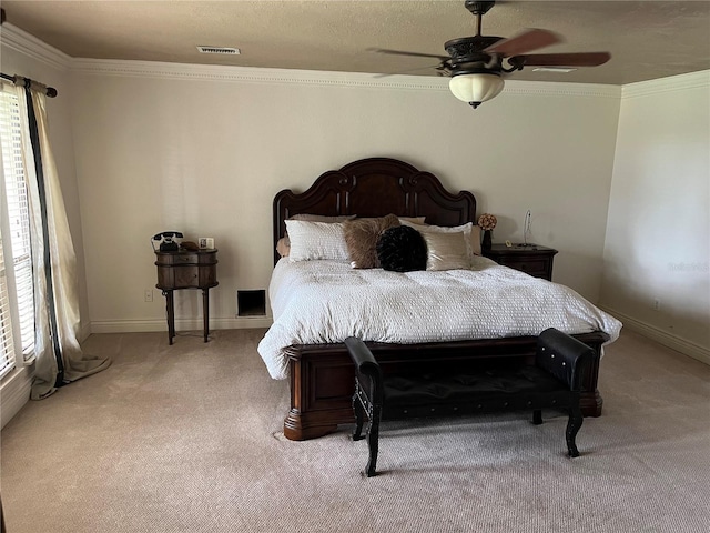 carpeted bedroom featuring crown molding and ceiling fan