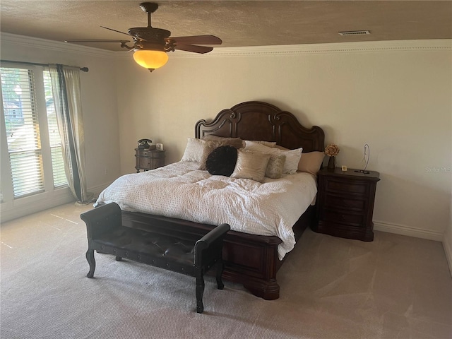 carpeted bedroom with ceiling fan, crown molding, and a textured ceiling