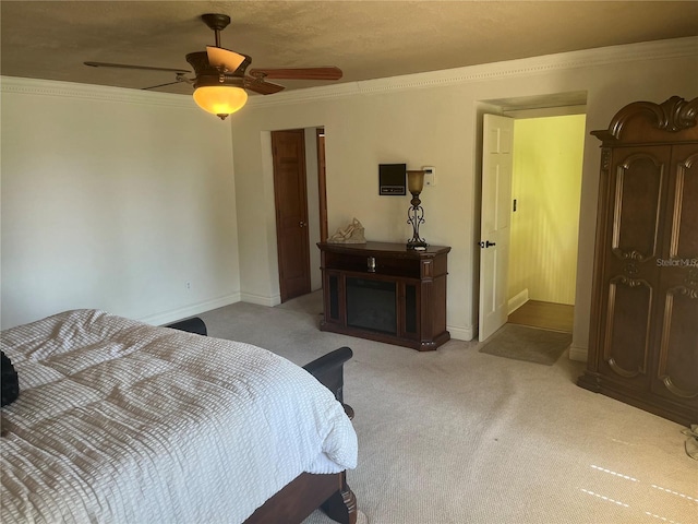 bedroom with ceiling fan, light colored carpet, and ornamental molding