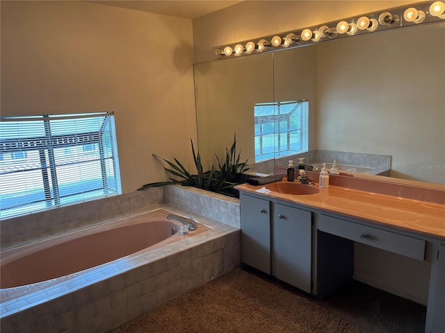 bathroom featuring vanity and tiled bath