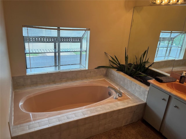 bathroom with vanity and tiled bath