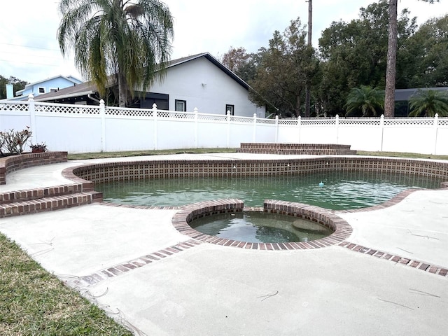 view of swimming pool with a patio and an in ground hot tub