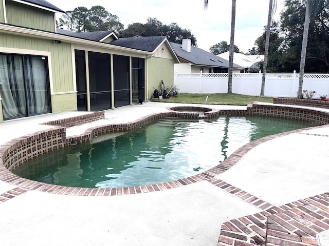 view of pool with a sunroom and an in ground hot tub