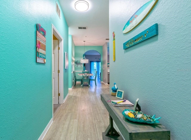 corridor with hardwood / wood-style floors