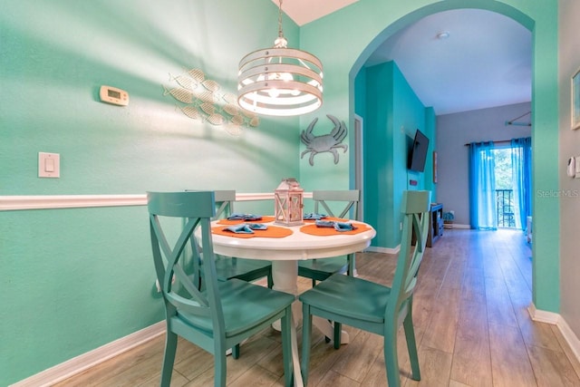 dining space featuring a chandelier and light hardwood / wood-style floors