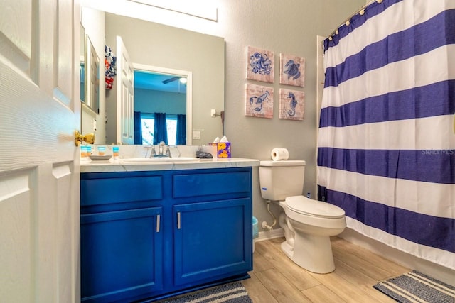 bathroom featuring hardwood / wood-style flooring, vanity, a shower with curtain, and toilet