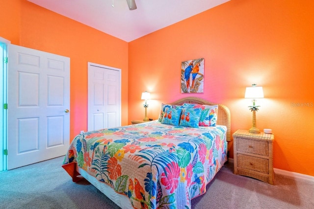 carpeted bedroom with ceiling fan and a closet