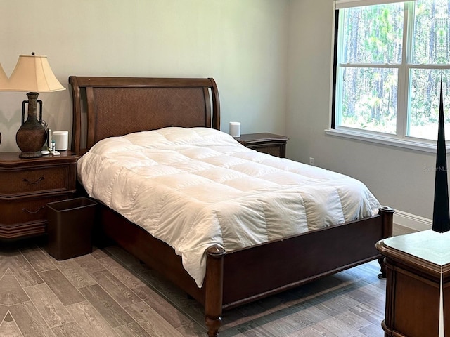 bedroom featuring hardwood / wood-style flooring and multiple windows