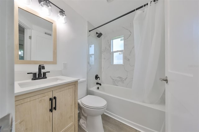 full bathroom with shower / bath combo with shower curtain, hardwood / wood-style flooring, vanity, and toilet