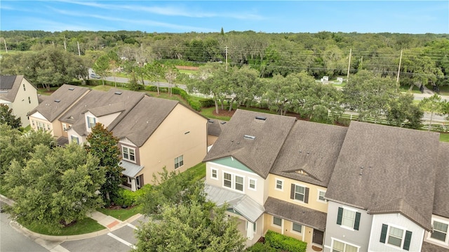 bird's eye view with a wooded view and a residential view