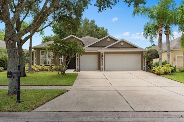 view of front of house with a garage and a front lawn