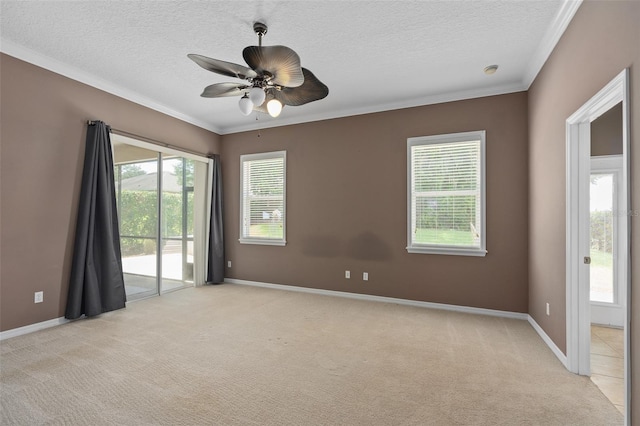 empty room featuring ceiling fan, light colored carpet, and ornamental molding