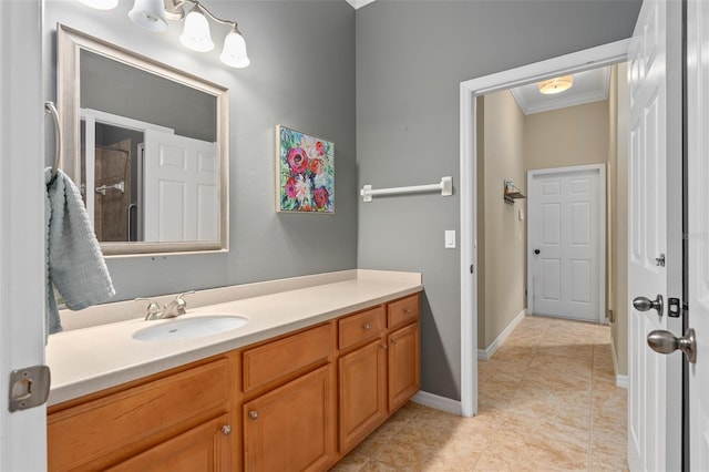 bathroom featuring vanity, tile patterned floors, and crown molding