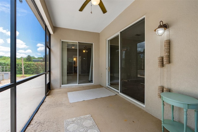 unfurnished sunroom featuring ceiling fan