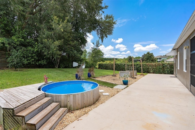 view of pool featuring a deck and a yard