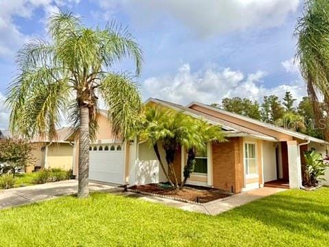 ranch-style home with a front lawn and a garage