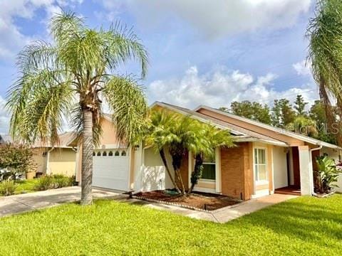 5135 Warrior Ln, Kissimmee, FL 34746 - ranch-style home featuring a garage, stucco siding, driveway, and a front yard