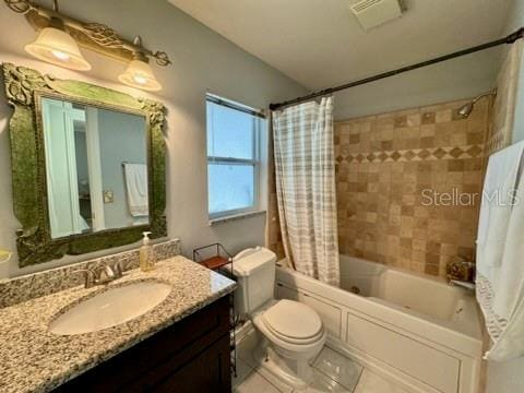 full bathroom with vanity, toilet, and shower / bathtub combination with curtain