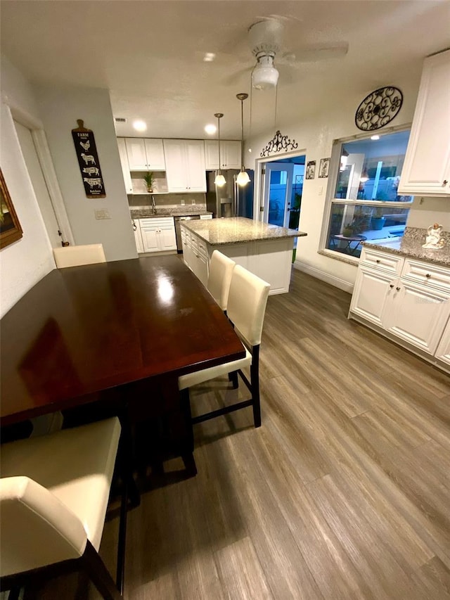 dining space featuring ceiling fan and hardwood / wood-style floors