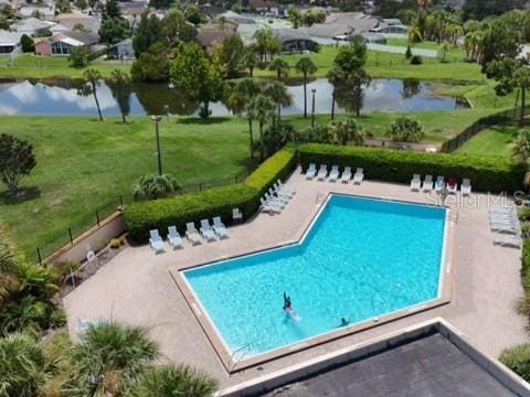 5135 Warrior Ln, Kissimmee, FL 34746 - pool with a yard, a water view, and a patio area