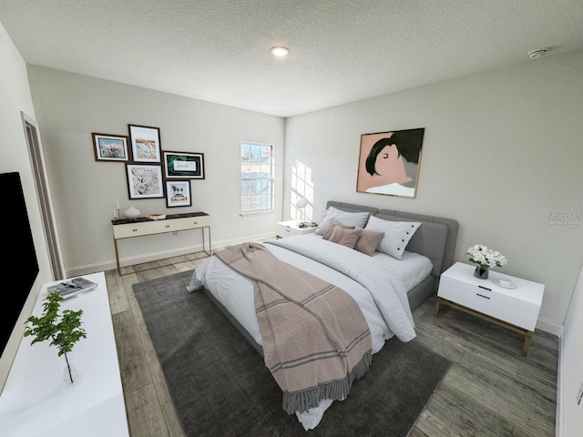 bedroom with a textured ceiling and dark hardwood / wood-style floors