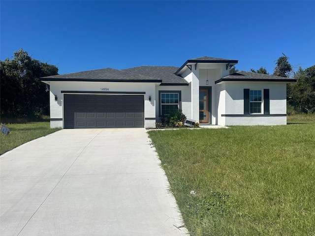 prairie-style home with a garage and a front lawn