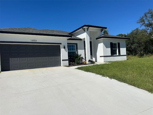 view of front of house with a garage and a front yard