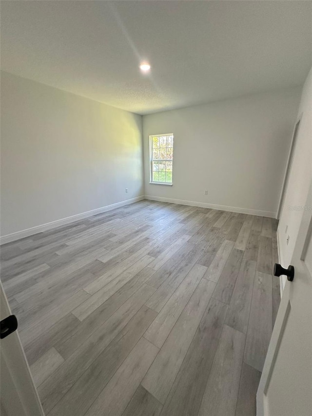 empty room with light hardwood / wood-style floors